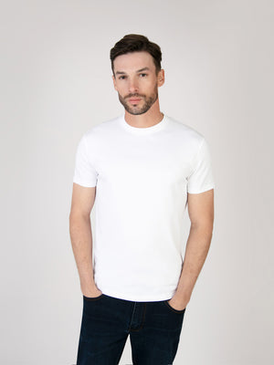 Model wearing a short sleeve white tee from organic cotton. Menswear UK
