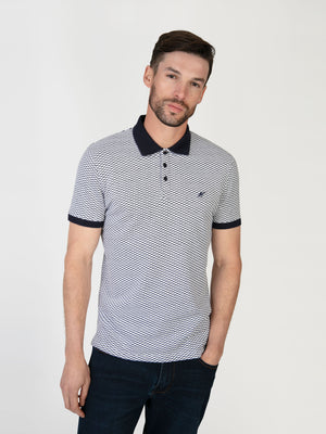 A man wearing a white and navy polo. Menswear UK.