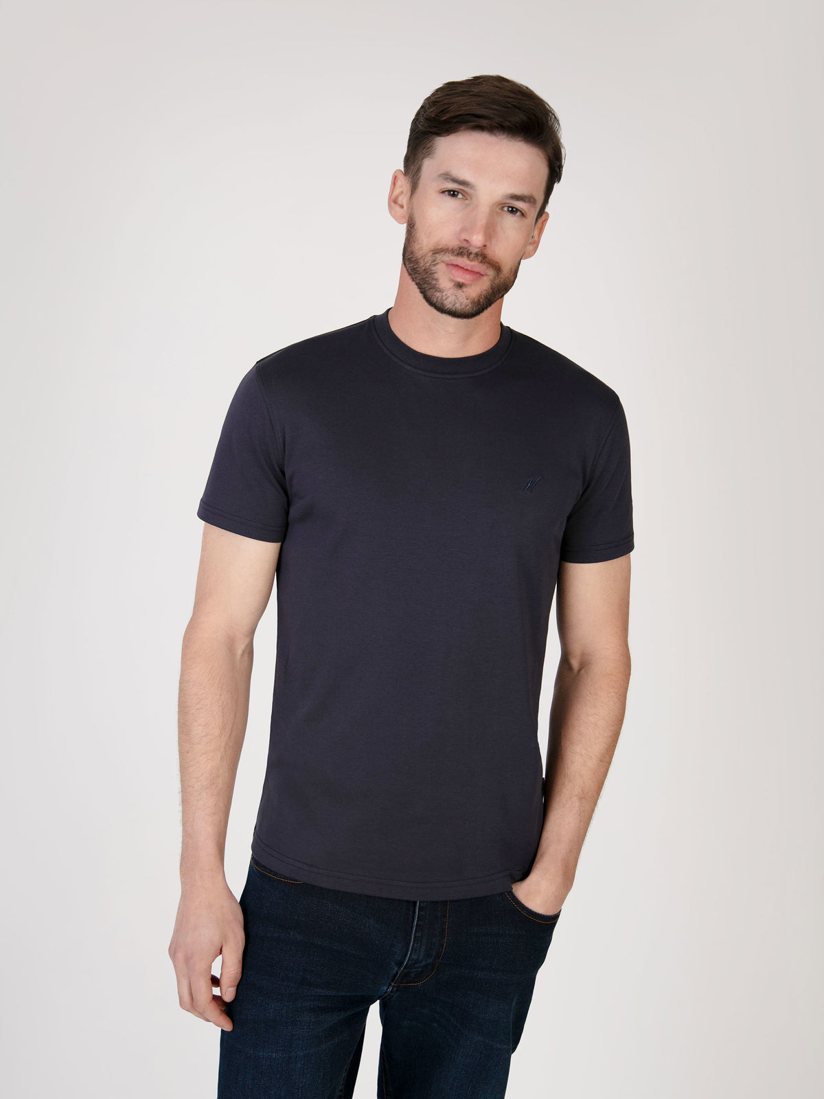 model wearing a short sleeve navy tee made from organic cotton. Menswear UK