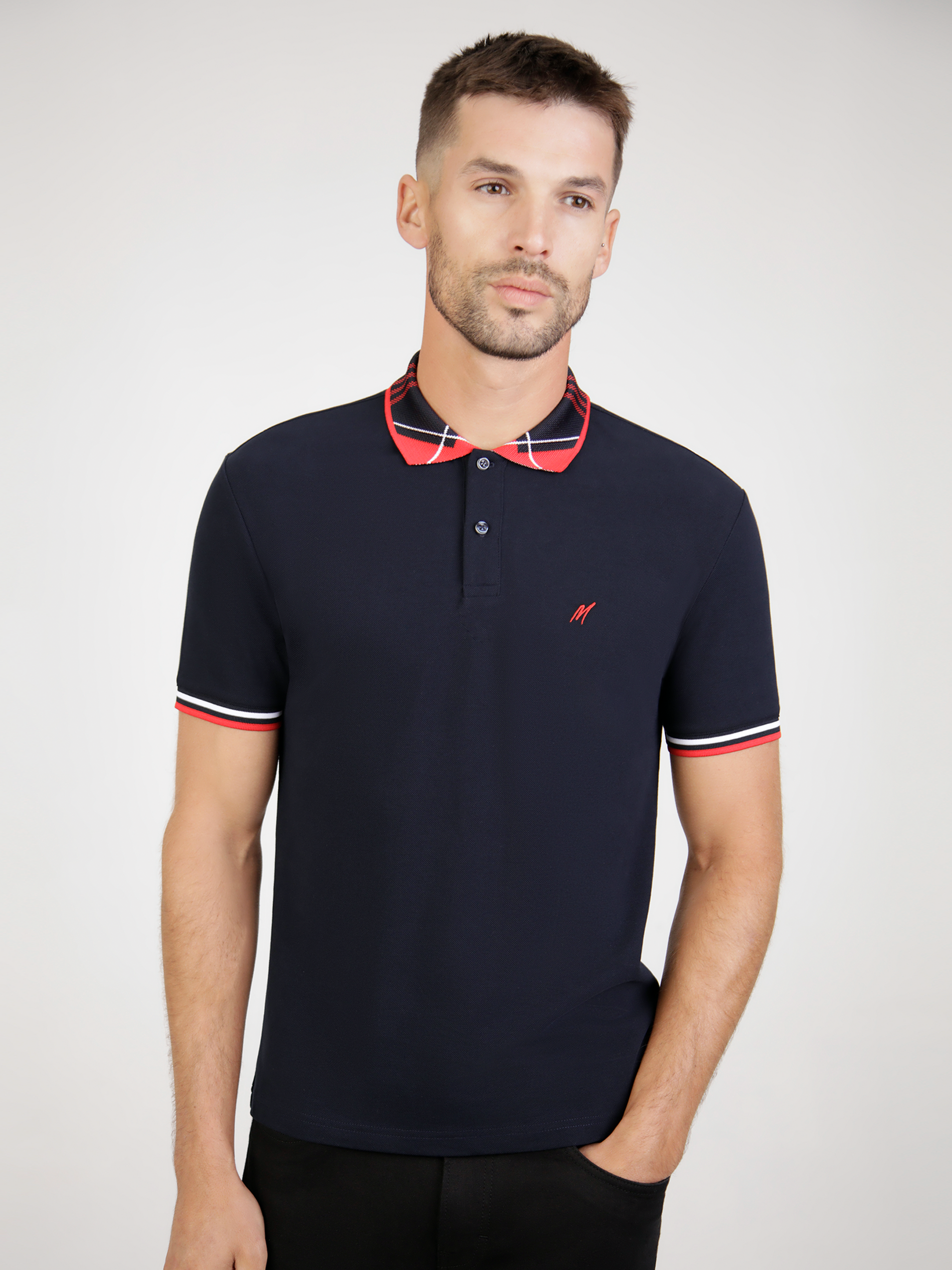 A navy polo with red collar detail.