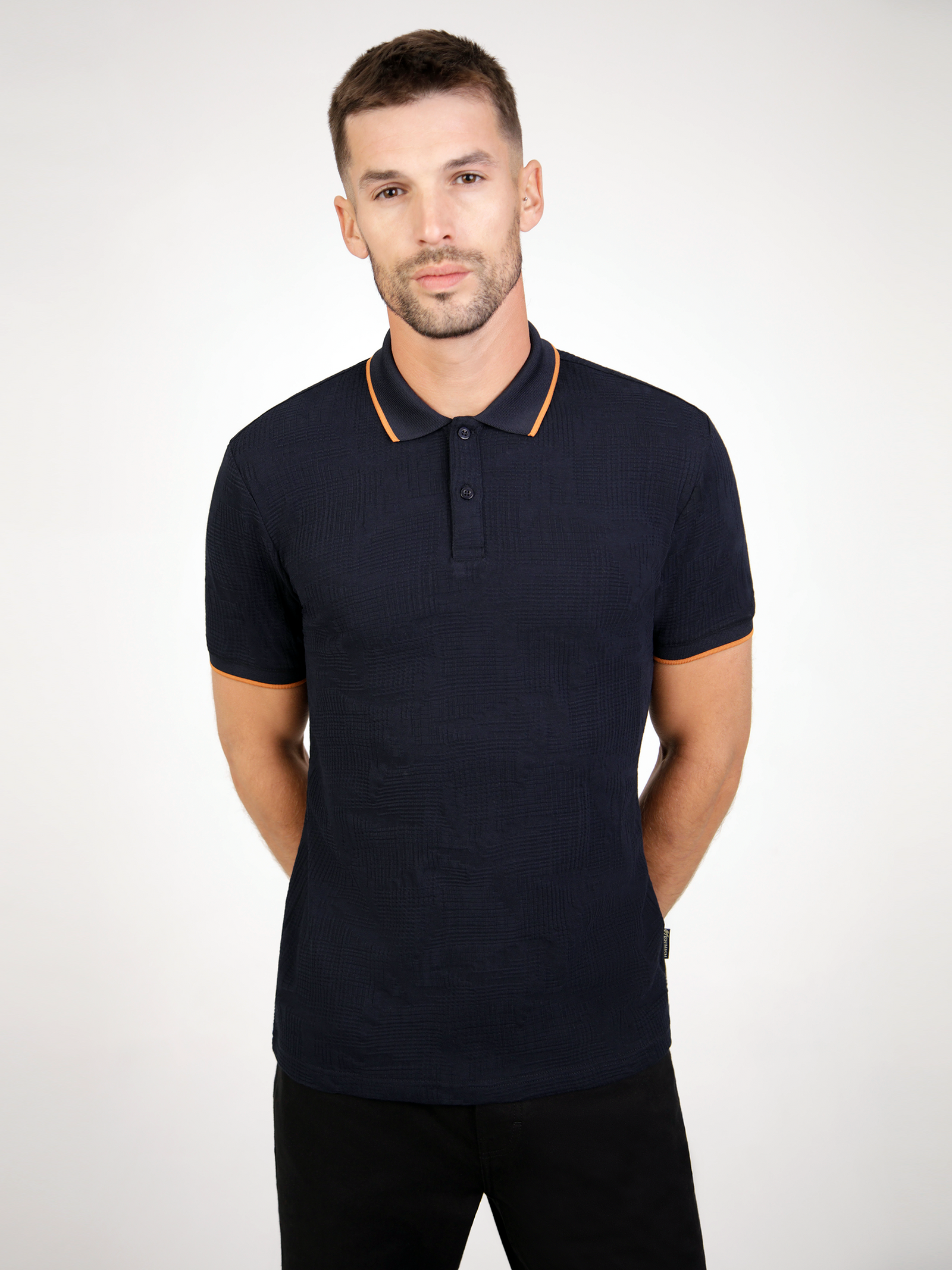 A black polo with contrast collar and cuff detail,