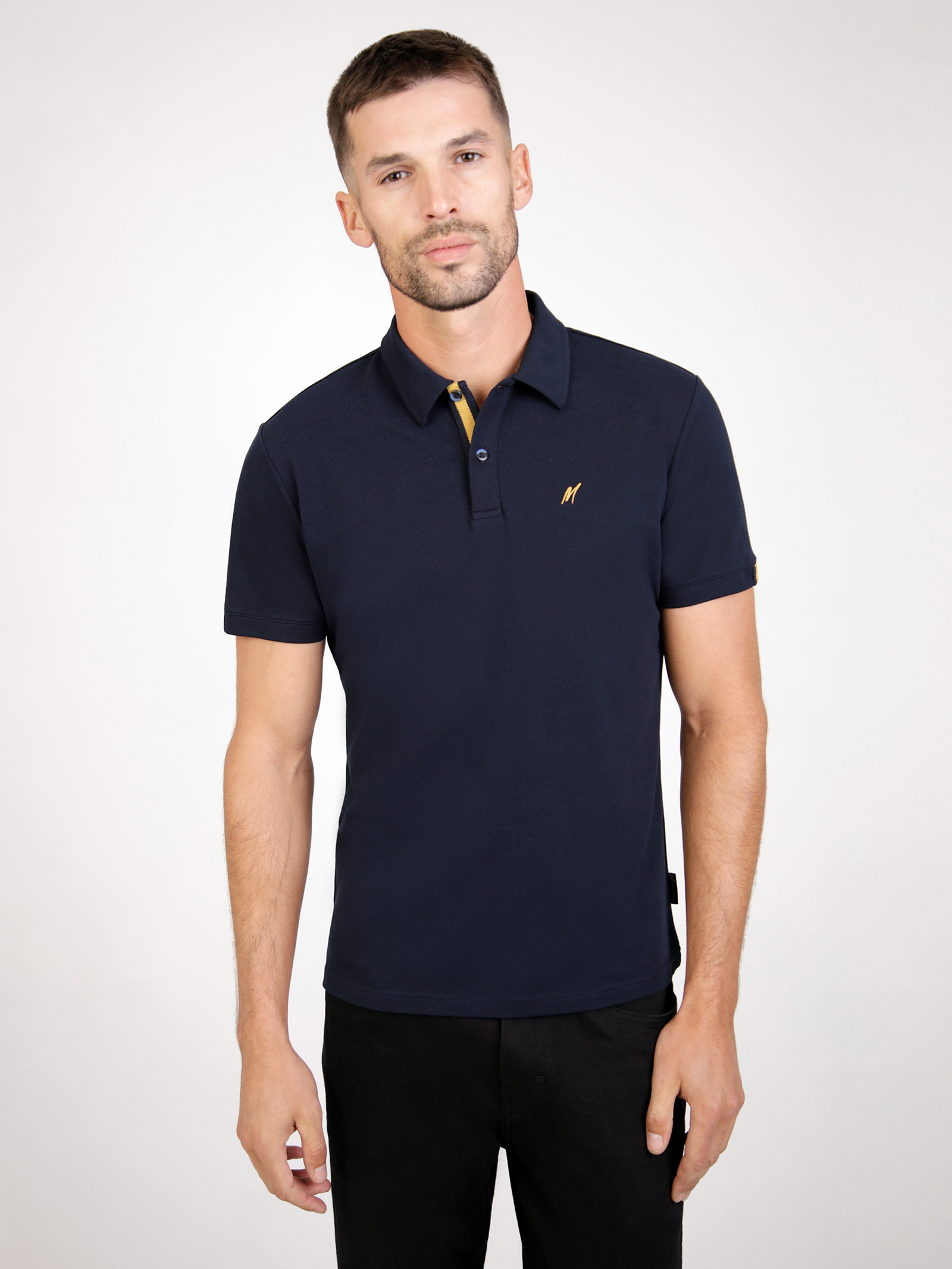 Mistral Navy short sleeve polo shirt with gold detailing and chest embroidery, folded neatly on a grey background.