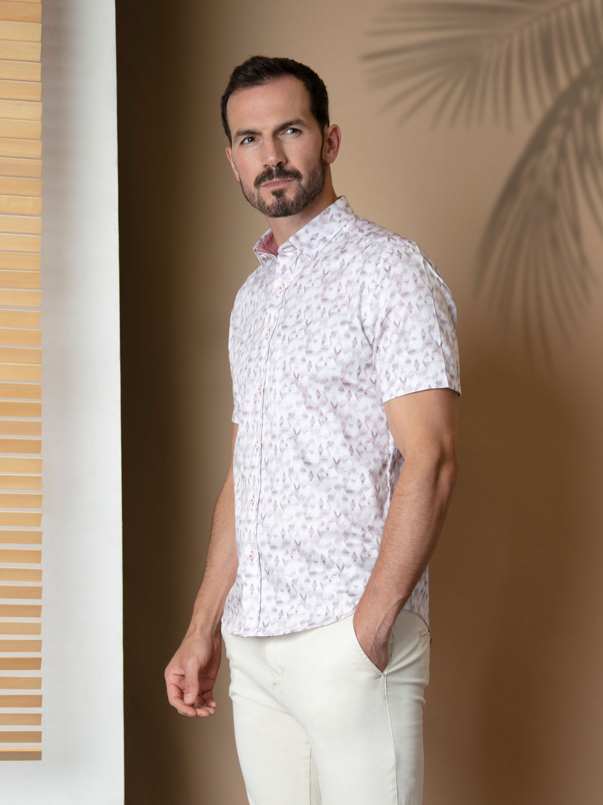 Model wearing the pink and white abstract short sleeve shirt. Menswear UK