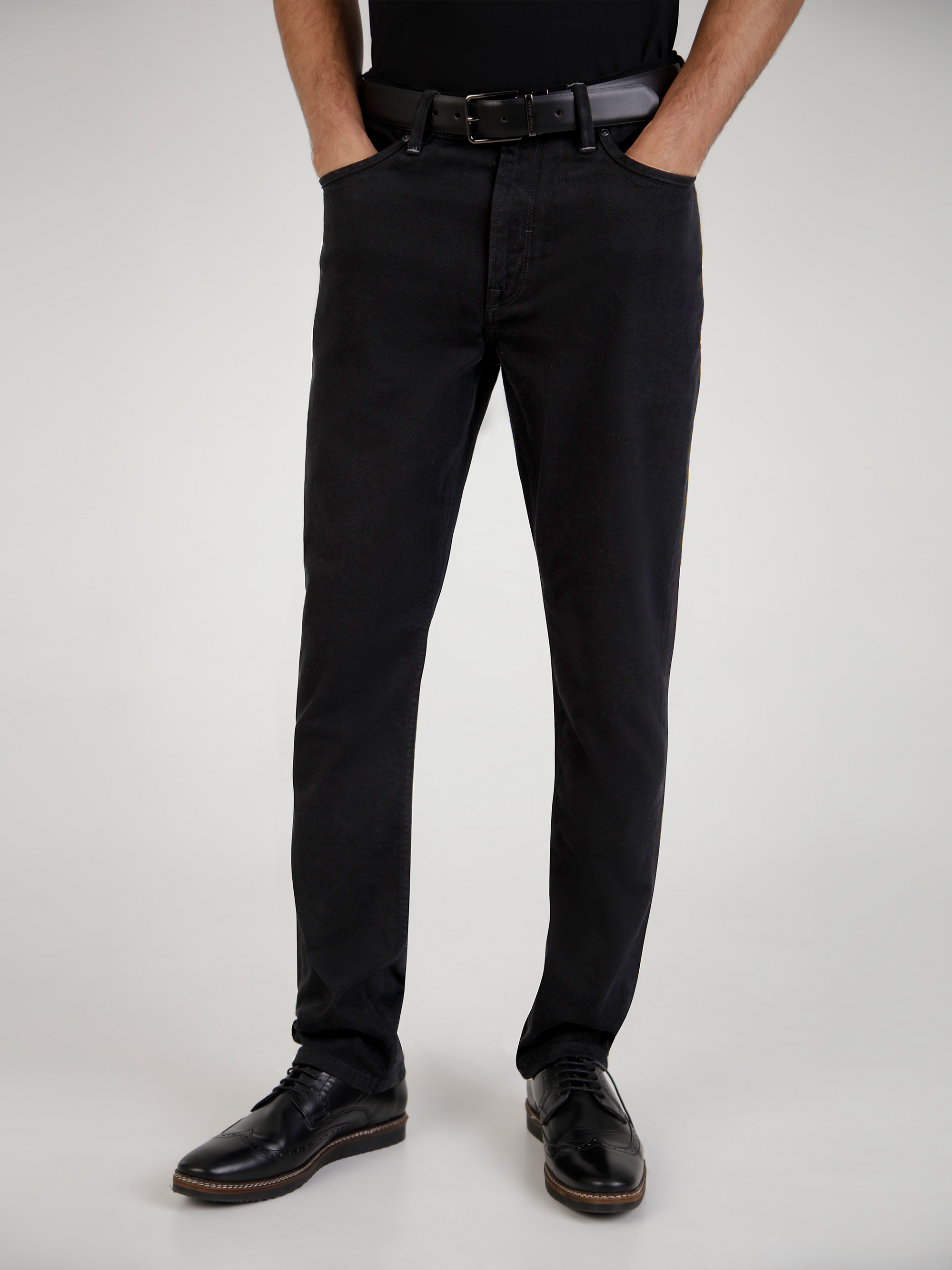 A black tapered fit jean, designed for men.