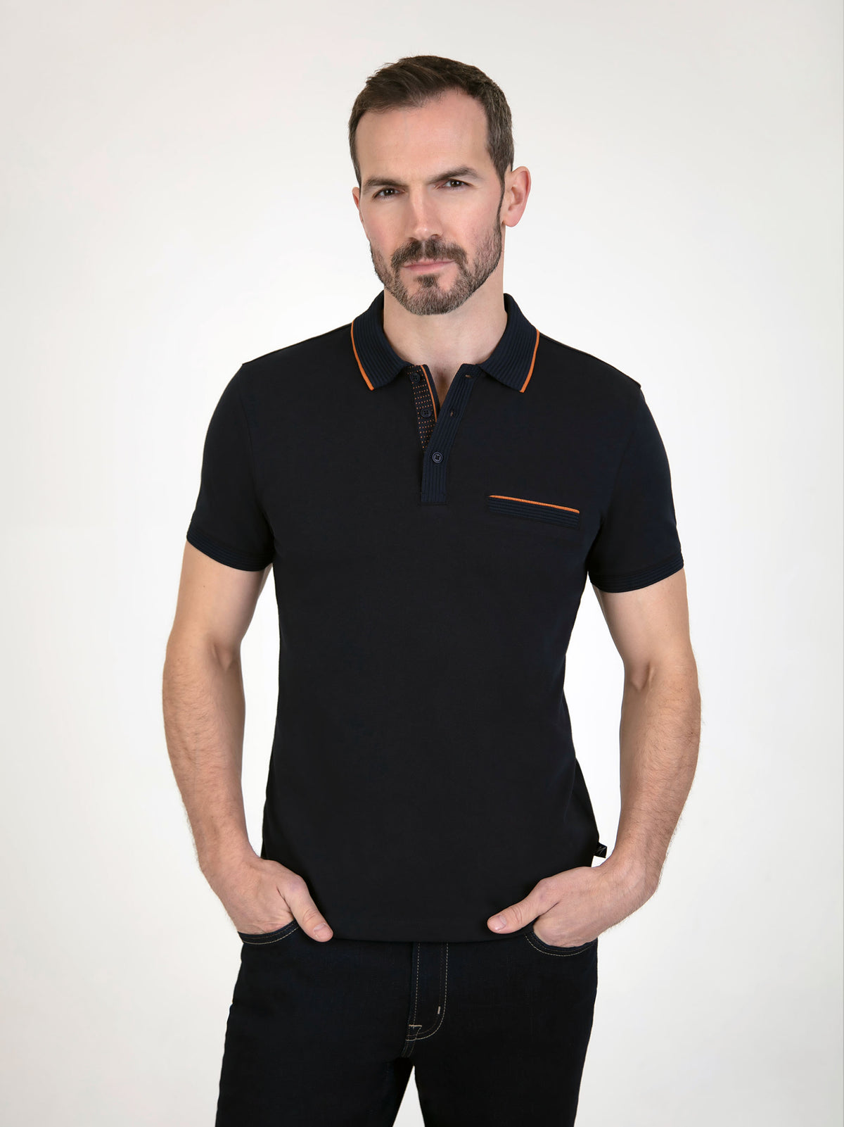 Model wearing a Tonto Navy S/S Polo shirt, featuring a stylish design with contrasting collar and pocket trim.