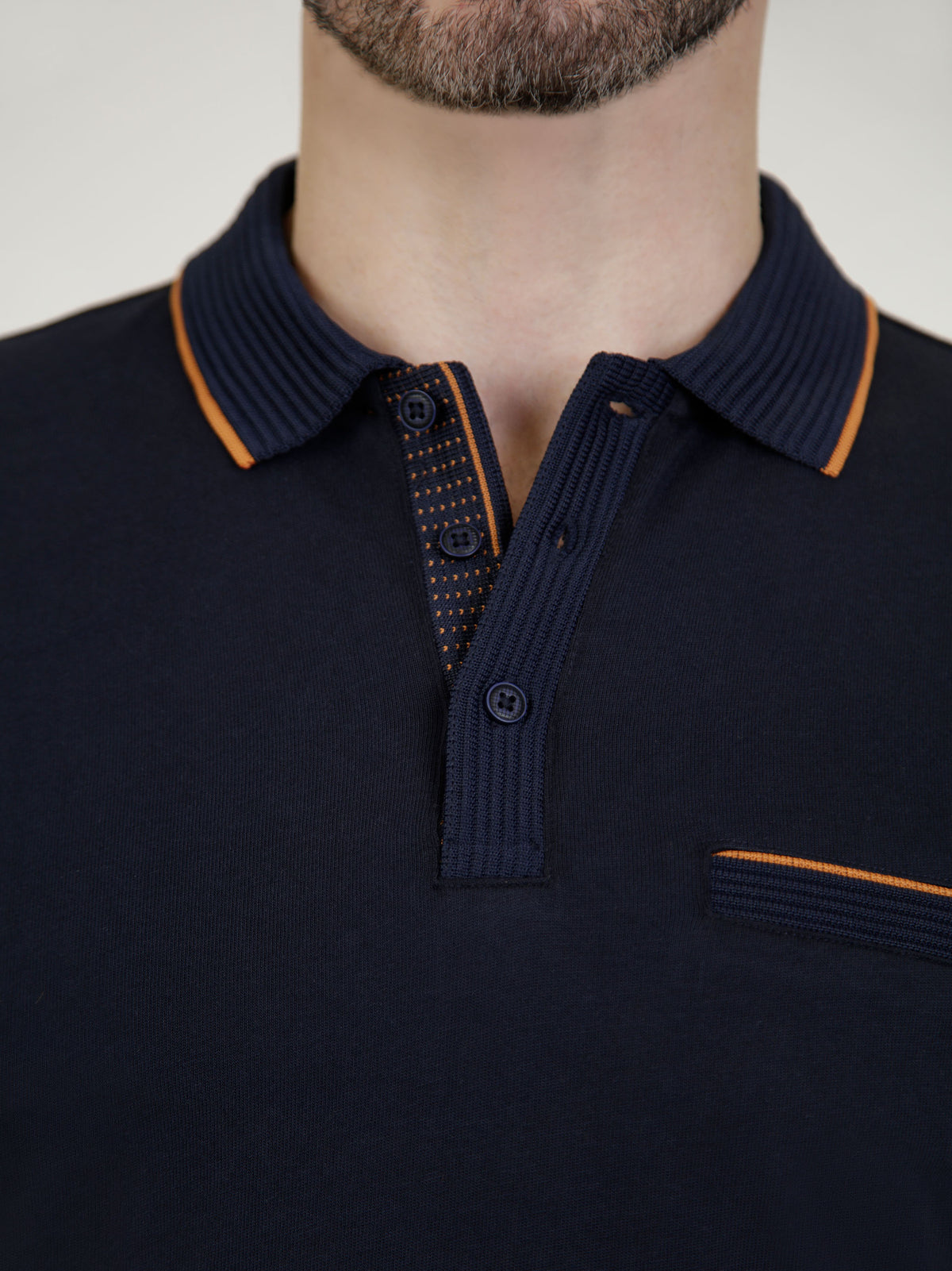 Close-up of Tonto Navy short-sleeve polo shirt with contrasting collar and buttons.