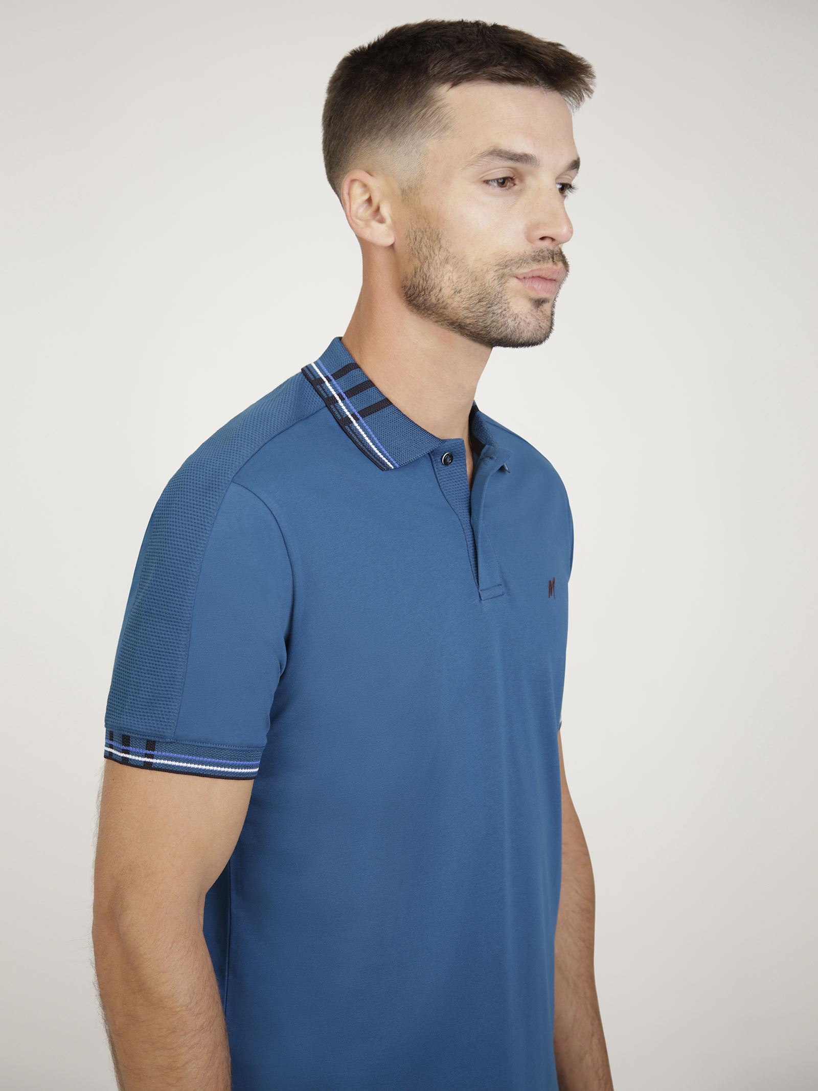 Vardar Teal short sleeve polo shirt featuring engineered rib collar and cuff, classic button placket, and embroidered logo.